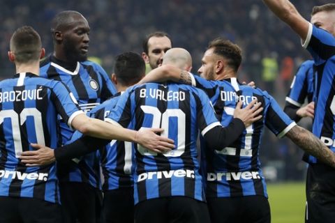 Inter Milan's Borja Valero, center, celebrates with teammates after scoring his side's second goal during an Italian Cup soccer match between Inter Milan and Cagliari at the San Siro stadium, in Milan, Italy, Tuesday, Jan. 14, 2020. (AP Photo/Antonio Calanni)