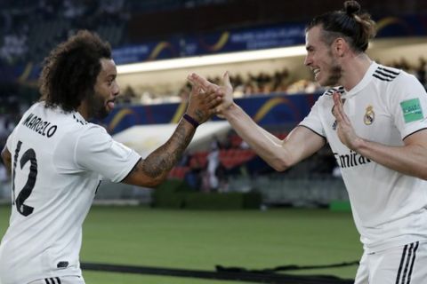 Real Madrid's midfielder Gareth Bale, right, celebrates with Marcelo after scoring his side's opening goal during the Club World Cup semifinal soccer match between Real Madrid and Kashima Antlers at Zayed Sports City stadium in Abu Dhabi, United Arab Emirates, Wednesday, Dec. 19, 2018. (AP Photo/Hassan Ammar)
