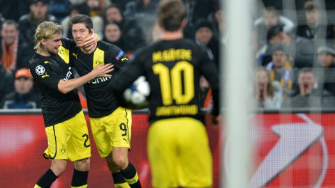 Robert Lewandowski  (C)  and Marcel Schmelzer  (L) of Borussia Dortmund celebrate scoring against FC Shakhtar during their UEFA Champions League round 16 football match in Donetsk on February 13, 2013. AFP PHOTO/ SERGEI SUPINSKY        (Photo credit should read SERGEI SUPINSKY/AFP/Getty Images)