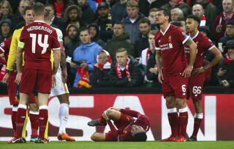 Liverpool's Alex Oxlade-Chamberlain grimaces on the ground after getting injured during the Champions League semifinal, first leg, soccer match between Liverpool and AS Roma at Anfield Stadium, Liverpool, England, Tuesday, April 24, 2018. (AP Photo/Dave Thompson)