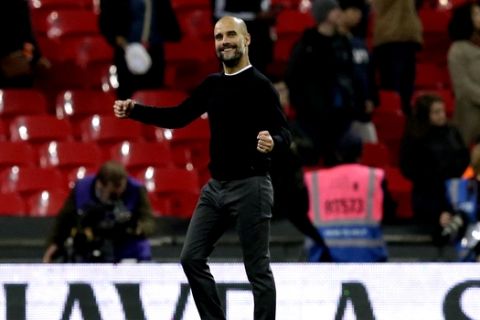 Manchester City coach Pep Guardiola celebrates at the end of the English Premier League soccer match between Tottenham Hotspur and Manchester City at Wembley stadium in London, England, Saturday, April 14, 2018. Manchester City won 3-1. (AP Photo/Tim Ireland)