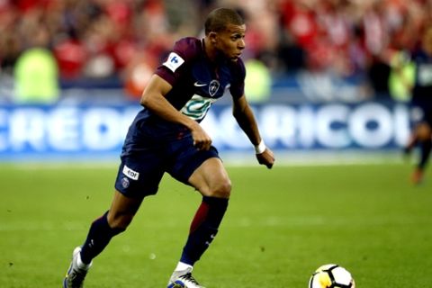 PSG's Kylian Mbappe runs with the ball during the French Cup soccer final Paris Saint Germain against Les Herbiers at the Stade de France stadium in Saint-Denis, outside Paris, Tuesday, May 8, 2018. Paris Saint-Germain beat resilient third-division side Les Herbiers 2-0 to win the French Cup. (AP Photo/Francois Mori)