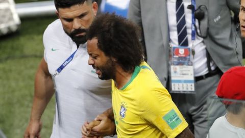Brazil's Marcelo leaves the pitch after suffering an injury during the group E match between Serbia and Brazil, at the 2018 soccer World Cup in the Spartak Stadium in Moscow, Russia, Wednesday, June 27, 2018. (AP Photo/Antonio Calanni)