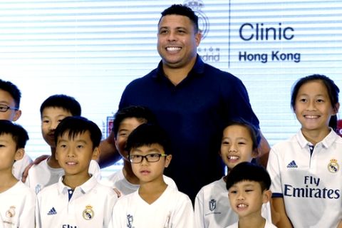 Brazilian football star Ronaldo Luis Nazario, center, poses with his fans during a promotional event for the Real Madrid Foundation Clinics in Hong Kong, Saturday, May 27, 2017. (AP Photo/Kin Cheung)
