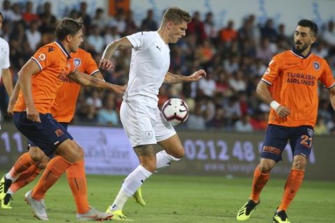 Istanbul Basaksehir's Alexandru Epureanu, left, tries to stop Burnley's Jeff Hendrick during the Europa League group soccer match between Istanbul Basaksehir and Burnley, at the Fatih Terim stadium in Istanbul, Thursday, Aug. 9, 2018. (AP Photo)