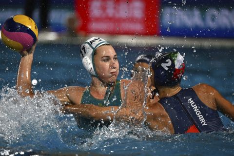 Tilly Kearns, left, and Dorottya Szilagyi in action, during the women's Water Polo quarterfinals match between Australia and Hungary, at the 19th FINA World Championships in Budapest, Hungary, Tuesday, June 28, 2022. (AP Photo/Anna Szilagyi)