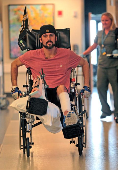 (Charlestown,  MA,  05/14/13) Marathon bombing victim,  Pete DiMartino wheels himself to therapy as his occupational therapist Julia Broyer follows at the Spaulding Rehabilitation Hospital Tuesday,  May 14,  2013.  Staff Photo by Matt Stone