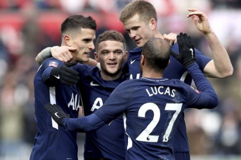 Tottenham Hotspur's Erik Lamela, left, celebrates scoring his side's second goal of the game against Swansea City with teammates during the English FA Cup, quarterfinal soccer match at the Liberty Stadium, Swansea, Wales, Saturday March 17, 2018. (Nick Potts/PA via AP)