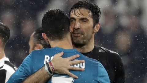 Juventus goalkeeper Gianluigi Buffon, right, hugs Real Madrid's Cristiano Ronaldo after the Champions League, round of 8, first-leg soccer match between Juventus and Real Madrid at the Allianz stadium in Turin, Italy, Tuesday, April 3, 2018. Real won 3-0. (AP Photo/Luca Bruno)