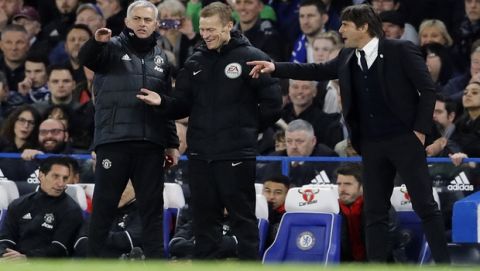 United manager Jose Mourinho, left, and Chelsea's team manager Antonio Conte, right, gesture during the English FA Cup quarterfinal soccer match between Chelsea and Manchester United at Stamford Bridge stadium in London, Monday, March 13, 2017. (AP Photo/Frank Augstein)