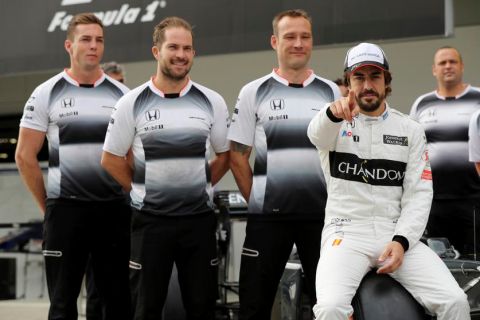 McLaren driver Fernando Alonso of Spain gestures during a team photo shoot in front of his team agar in pit lane ahead of the first practice session for the Japanese Formula One Grand Prix at the Suzuka International Circuit in Suzuka, Japan, Friday, Oct. 7, 2016. (AP Photo/Eugene Hoshiko)