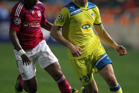 Apoel's Gustavo Manduca (R) challenges Lyon's Michel Bastos during the UEFA Champions League football match between Apoel Nicosia and Olympique Lyonnais at the GSP Stadium in the Cypriot capital Nicosia on March 7, 2012. AFP PHOTO/JACK GUEZ (Photo credit should read JACK GUEZ/AFP/Getty Images)