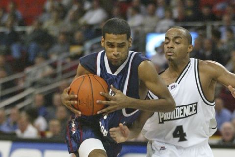 Fairleigh Dickinson's Manny Ubilla, left, drives to the basket against Providence's Sharaud Curry during the first half of a college basketball game, Tuesday, Nov. 14, 2006, in Providence, R.I. (AP Photo/Stew Milne) 