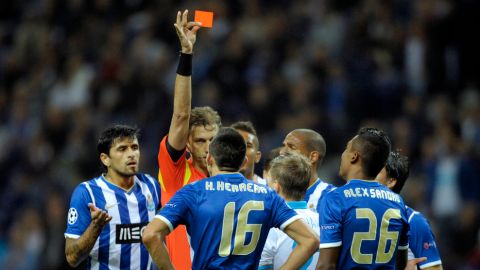 Italian referee Paolo Tagliavento shows the red card to Porto's Mexican midfielder Hector Herrera (C) during the UEFA Champions League Group G football match FC Porto vs Zenit at the Dragao Stadium in Porto on October 22, 2013.  AFP PHOTO / MIGUEL RIOPA        (Photo credit should read MIGUEL RIOPA/AFP/Getty Images)