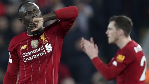 Liverpool's Sadio Mane celebrates after scoring the opening goal during the English Premier League soccer match between Liverpool and Wolverhampton Wanderers at Anfield Stadium, Liverpool, England, Sunday Dec. 29, 2019. (AP Photo/Jon Super)