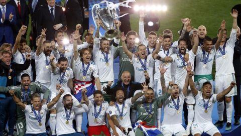 Real Madrid's Sergio Ramos lifts the trophy after winning the Champions League Final soccer match between Real Madrid and Liverpool at the Olimpiyskiy Stadium in Kiev, Ukraine, Saturday, May 26, 2018. Madrid defeated Liverpool by 3-1. (AP Photo/Darko Vojinovic)