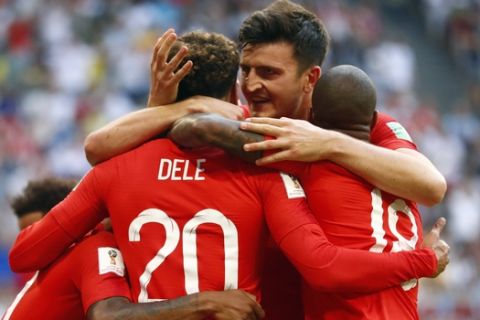 England's Dele Alli, left, celebrates with England's Harry Maguire, center and England's Marcus Rashford, right, after scoring his side's second goal during the quarterfinal match between Sweden and England at the 2018 soccer World Cup in the Samara Arena, in Samara, Russia, Saturday, July 7, 2018. (AP Photo/Matthias Schrader )