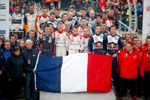 DEESIDE, WALES - NOVEMBER 15:  The drivers and team members observe a minutes silence as a mark of respect for the victims of the tragic events in Paris prior to the podium ceremony on November 15, 2015 in Deeside, Wales.  (Photo by Clive Rose/Getty Images)