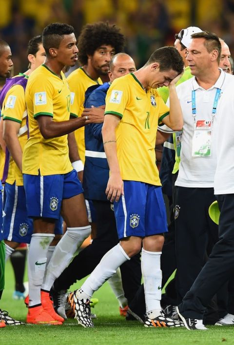 BELO HORIZONTE, BRAZIL - JULY 08: A dejected Oscar of Brazil (R) reacts with teammates after being defeated by Germany 7-1 during the 2014 FIFA World Cup Brazil Semi Final match between Brazil and Germany at Estadio Mineirao on July 8, 2014 in Belo Horizonte, Brazil.  (Photo by Buda Mendes/Getty Images)