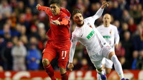 LIVERPOOL, ENGLAND - FEBRUARY 25:  Roberto Firmino of Liverpool and Kostas Stafylidis of Augsburg compete for the ball during the UEFA Europa League Round of 32 second leg match between Liverpool and FC Augsburg at Anfield on February 25, 2016 in Liverpool, United Kingdom.  (Photo by Clive Brunskill/Getty Images)