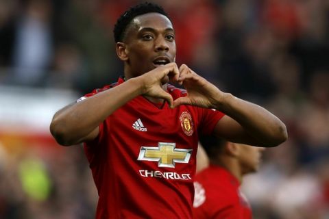 Manchester United's Anthony Martial celebrates scoring his side's second goal of the game during the English Premier League soccer match between Manchester United and Watford, at Old Trafford, in Manchester, England, Saturday March 30, 2019. (Martin Rickett/PA via AP)