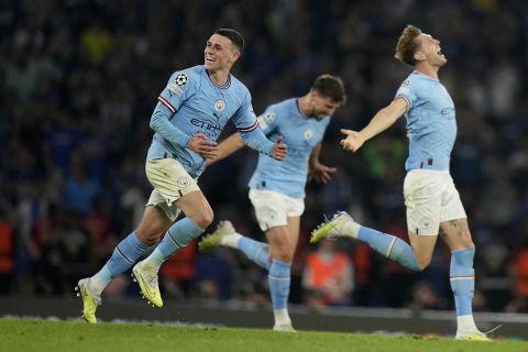 Manchester City's Phil Foden, Ruben Dias and John Stones, from left, celebrate at the end of the Champions League final soccer match between Manchester City and Inter Milan at the Ataturk Olympic Stadium in Istanbul, Turkey, Saturday, June 10, 2023. Manchester City won 1-0. (AP Photo/Francisco Seco)