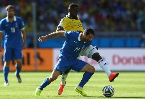 BELO HORIZONTE, BRAZIL - JUNE 14:  Giorgos Karagounis of Greece holds off a challenge by Jackson Martinez of Colombia during the 2014 FIFA World Cup Brazil Group C match between Colombia and Greece at Estadio Mineirao on June 14, 2014 in Belo Horizonte, Brazil.  (Photo by Jeff Gross/Getty Images)