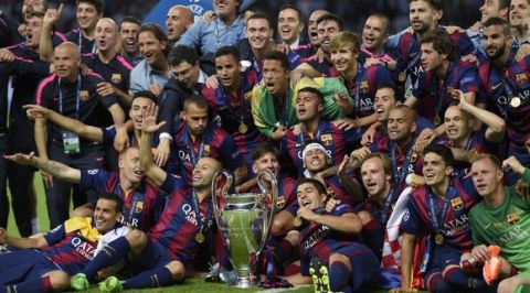 Barcelona's players celebrate with the trophy after the UEFA Champions League Final football match between Juventus and FC Barcelona at the Olympic Stadium in Berlin on June 6, 2015.  FC Barcelona won the match 1-3.   AFP PHOTO / LLUIS GENE        (Photo credit should read LLUIS GENE/AFP/Getty Images)