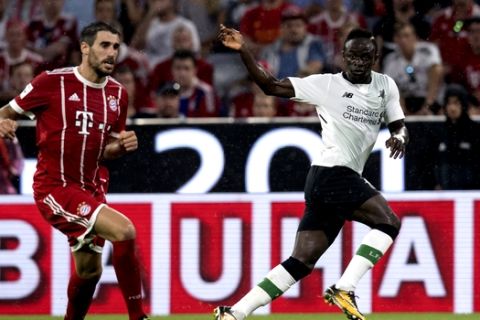 Bayern Munich's Javi Martinez, left, and Liverpool's Sadio Mane vie for the ball during the Audi Cup semifinal soccer match between FC Bayern Munich and Liverpool FC in the Allianz Arena in Munich, Germany, Tuesday, Aug. 1 2017. (Sven Hoppe/dpa via AP)