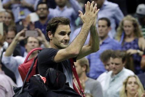 Roger Federer, of Switzerland, acknowledges spectators while leaving the court after losing to Juan Martin del Potro, of Argentina, during the quarterfinals of the U.S. Open tennis tournament, Wednesday, Sept. 6, 2017, in New York. (AP Photo/Julio Cortez)