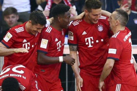 Bayern defender Niklas Suele, center right, celebrates with teammates after scoring his side's opening goal during the German Bundesliga soccer match between Bayern Munich and Werder Bremen at the Allianz Arena in Munich, Germany, Saturday, April 20, 2019. (AP Photo/Matthias Schrader)