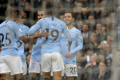 Manchester City's Bernardo Silva, right, celebrates with teammates after scoring his side's opening goal during the English Premier League soccer match between Manchester City and Bournemouth at Etihad stadium in Manchester, England, Saturday, Dec. 1, 2018. (AP Photo/Rui Vieira)