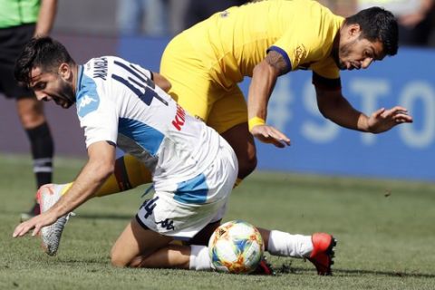 Napoli's Kostas Manolas (44), left, and Barcelona forward Luis Suarez try contouring the ball during the first half of a soccer match, Saturday, Aug. 10, 2019, in Ann Arbor, Mich. (AP Photo/Carlos Osorio)