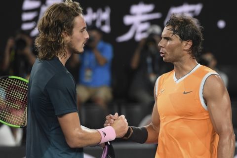 Spain's Rafael Nadal, right, is congratulated by Greece's Stefanos Tsitsipas after winning their semifinal at the Australian Open tennis championships in Melbourne, Australia, Thursday, Jan. 24, 2019.(AP Photo/Andy Brownbill)