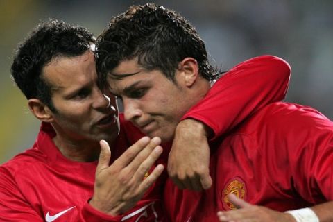 Manchester United's Cristiano Ronaldo, a former Sporting player, celebrates with teammate Ryan Giggs, left, after scoring a goal during their Champions League group F soccer match Wednesday, Sept. 19 2007, at the Alvalade stadium in Lisbon, Portugal. Manchester United defeated Sporting 1-0. (AP Photo/Octavio Passos)