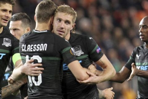 Krasnodar's Viktor Claesson, center front, celebrates with teammates after scoring his side's opening goal during the Europa League round of 16, first leg soccer match between Valencia and FC Krasnodar at the Mestalla Stadium in Valencia, Spain, Thursday, March 7, 2019. (AP Photo/Alberto Saiz)