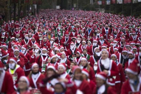 People dressed in Santa Claus costumes take part in a morning run in Madrid, Sunday, Dec. 10, 2017. Thousands of people ran in the annual Santa race through the streets of the Spanish capital. (AP Photo/Francisco Seco)