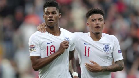 England's Marcus Rashford, left, celebrates with England's Jadon Sancho after scoring his side's opening goal from the penalty spot during the UEFA Nations League semifinal soccer match between Netherlands and England at the D. Afonso Henriques stadium in Guimaraes, Portugal, Thursday, June 6, 2019. (AP Photo/Luis Vieira)