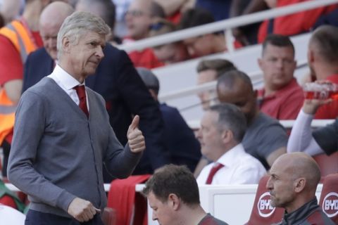 Arsenal's French manager Arsene Wenger gives a thumbs up as he takes his eat for the second half during the English Premier League soccer match between Arsenal and Burnley at the Emirates Stadium in London, Sunday, May 6, 2018. The match is Arsenal manager Arsene Wenger's last home game in charge after announcing in April he will stand down as Arsenal coach at the end of the season after nearly 22 years at the helm. (AP Photo/Matt Dunham)