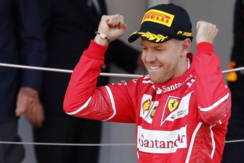 Ferrari driver Sebastian Vettel of Germany celebrates on the podium after winning the Formula One Grand Prix at the Monaco racetrack in Monaco, Sunday, May 28, 2017. (AP Photo/Frank Augstein)