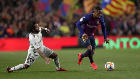 Barcelona forward Malcom, right, and Real defender Marcelo run for the ball during the Copa del Rey semifinal first leg soccer match between FC Barcelona and Real Madrid at the Camp Nou stadium in Barcelona, Spain, Wednesday Feb. 6, 2019. (AP Photo/Manu Fernandez)