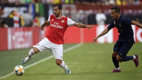 FILE - In this July 23, 2019 file photo, then Arsenal midfielder Henrikh Mkhitaryan, left, reaches for the ball against Real Madrid forward Lucas Vazquez during an International Champions Cup soccer match, in Landover, Md. Mkhitaryan was presented at Roma on Tuesday, Sept. 10, 2019. (AP Photo/Nick Wass, file)