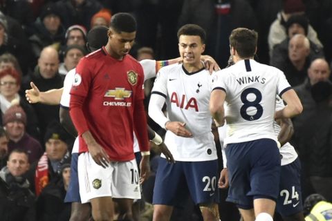 Tottenham's Dele Alli, centre, celebrates after scoring his side's opening goal during the English Premier League soccer match between Manchester United and Tottenham Hotspur at Old Trafford in Manchester, England, Wednesday, Dec. 4, 2019. (AP Photo/Rui Vieira)
