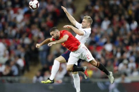 England's Luke Shaw, right, jumps for the ball with Spain's Dani Carvajal during the UEFA Nations League soccer match between England and Spain at Wembley stadium in London, Saturday Sept. 8, 2018. (AP Photo/Frank Augstein)