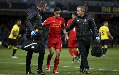 Liverpool's Philippe Coutinho is led off the pitch with an injury during the English Premier League soccer match against Watford at Vicarage Road, London, Monday May 1, 2017. (John Walton/PA via AP)