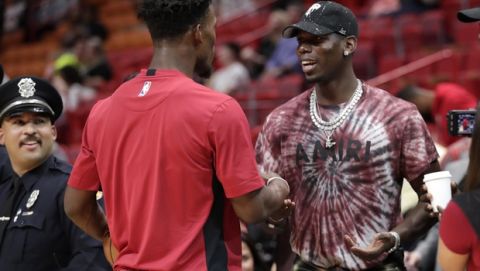 Miami Heat forward Jimmy Butler, left, talks with Manchester United midfielder Paul Pogba, right, before a NBA basketball game between the Miami Heat and New Orleans Pelicans, Saturday, Nov. 16, 2019, in Miami. (AP Photo/Lynne Sladky)