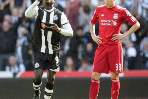 Newcastle United's Senegalese striker Papiss Demba Cisse (L) celebrates after scoring the first goal against Liverpool in front of Liverpool's Jonjo Shelvey (R) on April 1, 2012 during an English FA Premier League football match at St James' Park in Newcastle upon Tyne. AFP PHOTO / GRAHAM STUART
RESTRICTED TO EDITORIAL USE. No use with unauthorized audio, video, data, fixture lists, club/league logos or "live" services. Online in-match use limited to 45 images, no video emulation. No use in betting, games or single club/league/player publications. (Photo credit should read GRAHAM STUART/AFP/Getty Images)