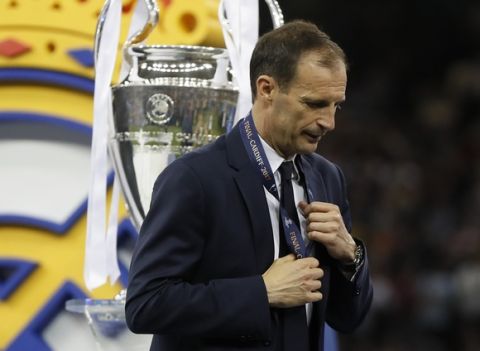 Juventus head coach Massimiliano Allegri gestures after receiving the medal after the Champions League soccer final between Juventus and Real Madrid at the Millennium Stadium in Cardiff, Wales, Saturday, June 3, 2017. (AP Photo/Kirsty Wigglesworth)