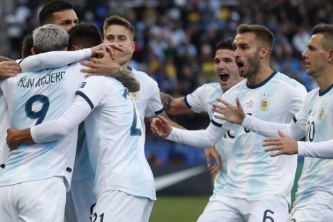 Argentina's Sergio Aguero, left, celebrates with teammates after scoring his side's opening goal against Chile during Copa America third-place soccer match at the Arena Corinthians in Sao Paulo, Brazil, Saturday, July 6, 2019. (AP Photo/Victor R. Caivano)