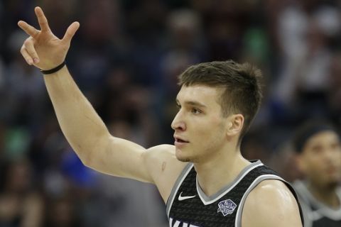 Sacramento Kings guard Bogdan Bogdanovic celebrates after scoring a three point shot during the first quarter of an NBA basketball game against the Golden State Warriors Saturday, March 31, 2018, in Sacramento, Calif. The Warriors won 112-96. (AP Photo/Rich Pedroncelli)